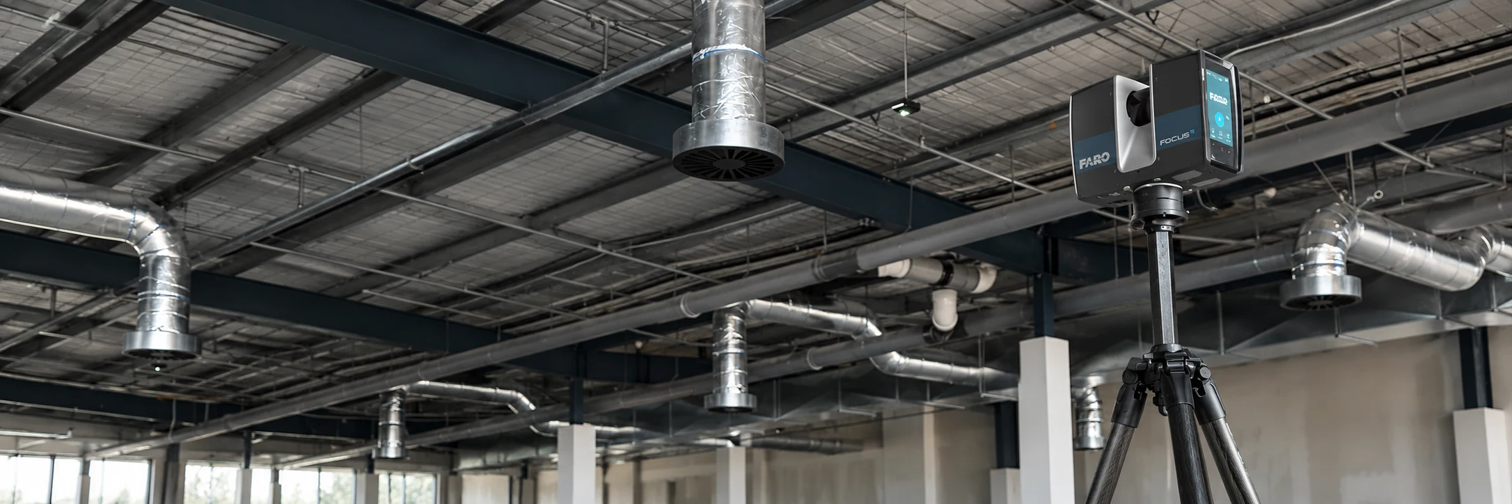 3D laser scanner set up inside a commercial interior with exposed services